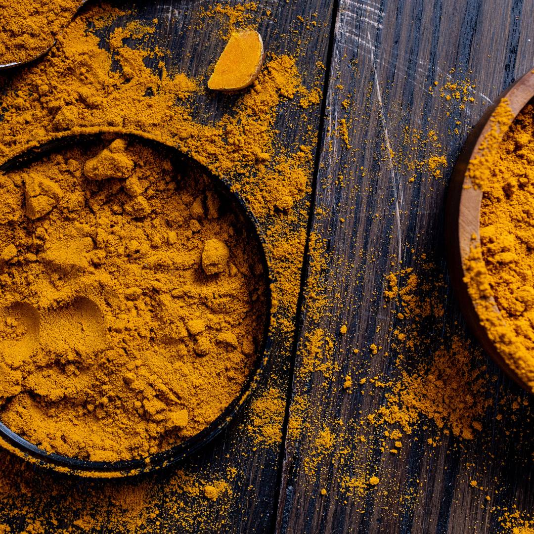 Pot of superfood tumeric on a wooden table 