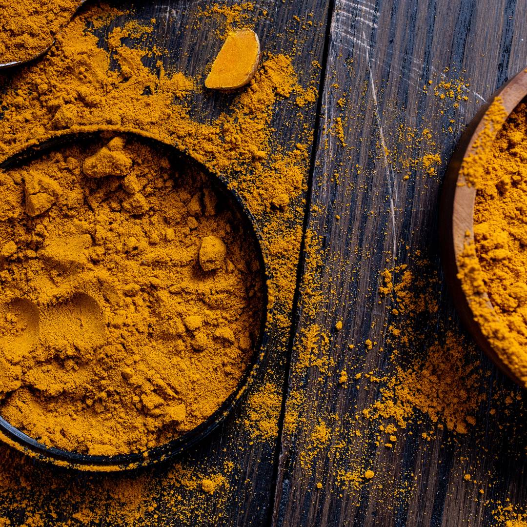Pot of superfood tumeric on a wooden table 