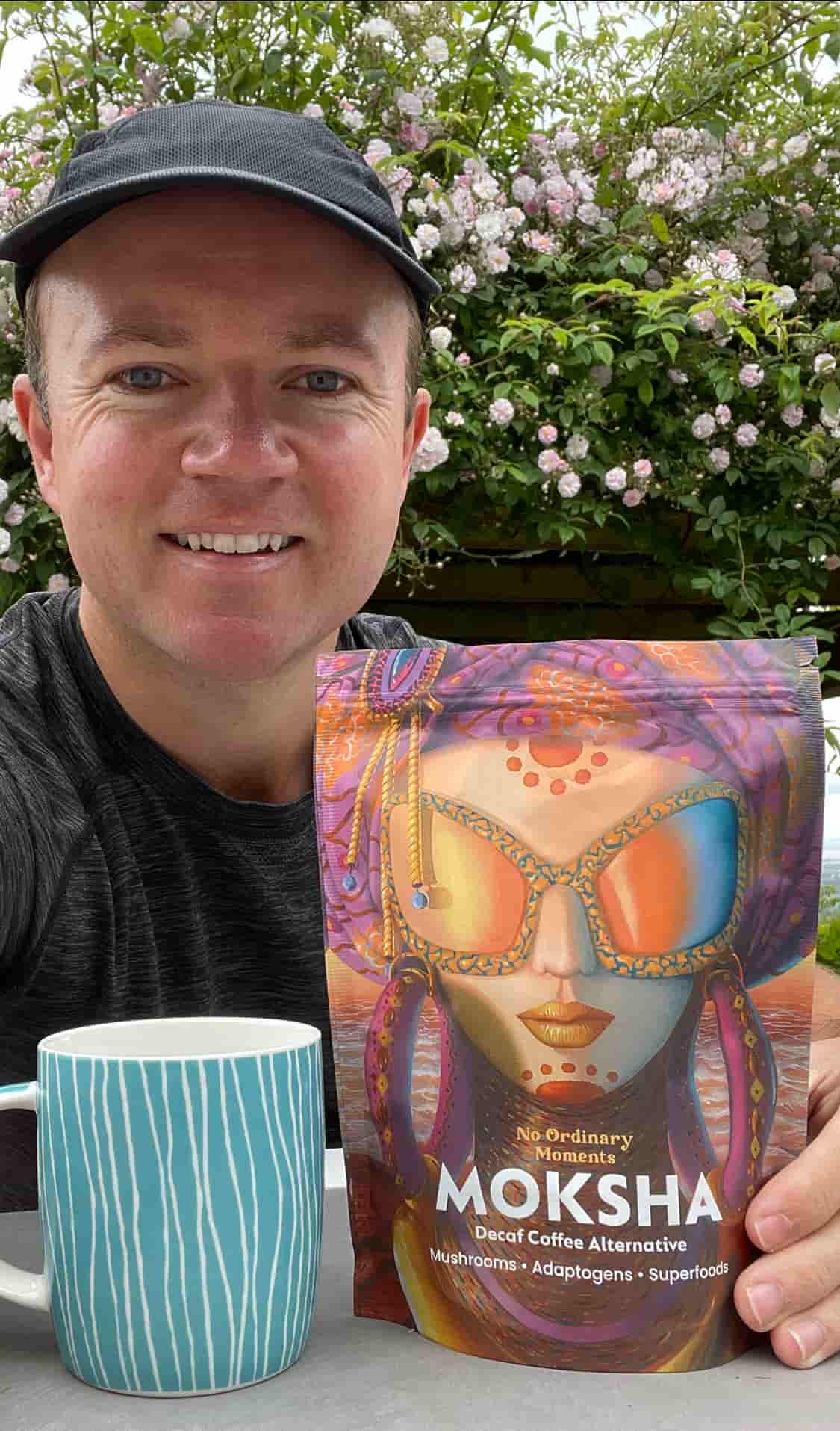 Chris, founder of No Ordinary Moments, holding a Moksha pouch outdoors.